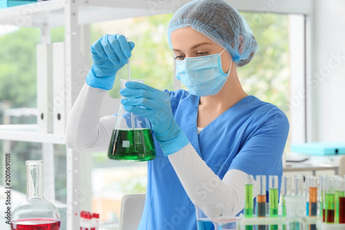Female chemist with flask i...