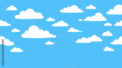 The serene landscape features fluffy clouds floating gently across the blue sky on a sunny day outdoors.