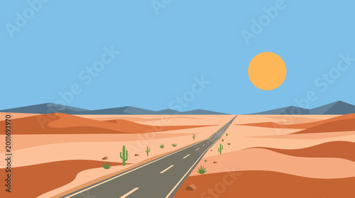 A desert road stretches towards mountains under a sunny clear blue sky with sandy dunes.
