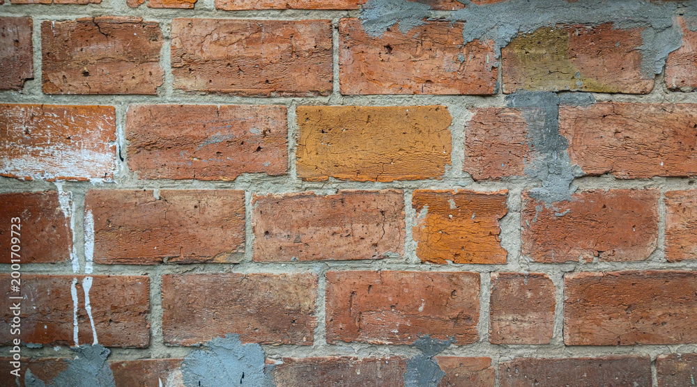 Fototapeta premium Old red brick wall texture background, weathered brickwork with cement and white paint drips