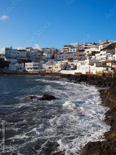 Rocky beach and white houses on the Atlantic Ocean coast in the picturesque village of Tufia on Gran Canaria, Canary Islands, Spain