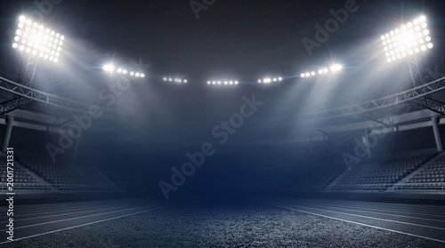 A darkened sports stadium with bright lights.