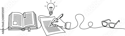 Hand writing in notebook with light bulb idea and glasses creative process learning and education concept brainstorming.