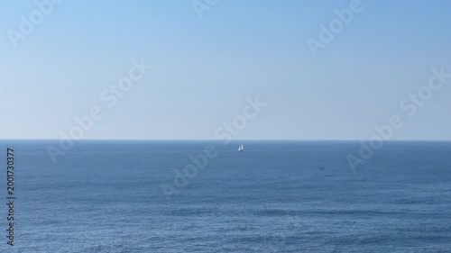  boats, sailboat, and the caves roof hole visible along the Algarve coast in Portugal