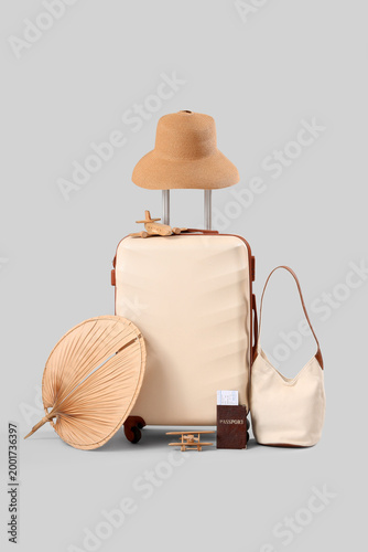 Beige suitcase with hat and...