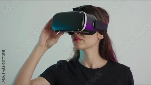 Woman is using virtual reality headset. Image with glitch effect.
