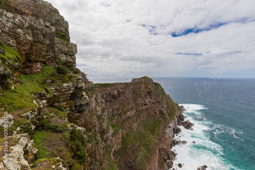 Cape Point is a promontory at the southeast corner of the Cape Peninsula, a mountainous and scenic landform with rugged rocks and sheer cliffs towering more than 200 metres above the sea and cutting d