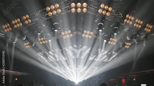 Concert stage lighting beams shine.