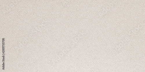 A seamless white paper and canvas texture features a blank rough surface with a subtle vintage linen pattern design for a light material backdrop