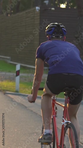 A cyclist trains before a competition. Or an active break after a sedentary day at work.