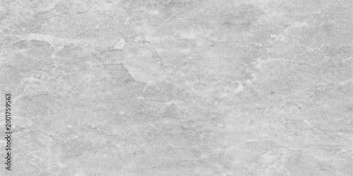 A rough winter background featuring a cold grunge texture of dirty snow on a gray cement wall and icy ground with a blank marble pattern