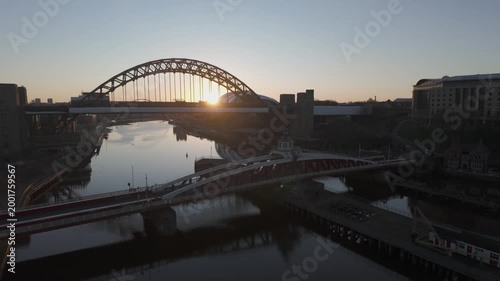 Pan from interior of High Level Bridge to sun rising behind Tyne Bridge on a beautiful morning in Newcastle. Swing and Millennium bridges are also seen 