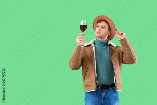 Young man with glass of win...