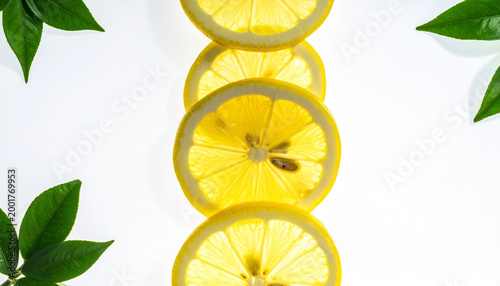 Translucent Lemon Slices with Green Leaves on White