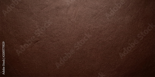 A close-up view of textured brown leather reveals an intricate surface. The texture create a compelling backdrop.
