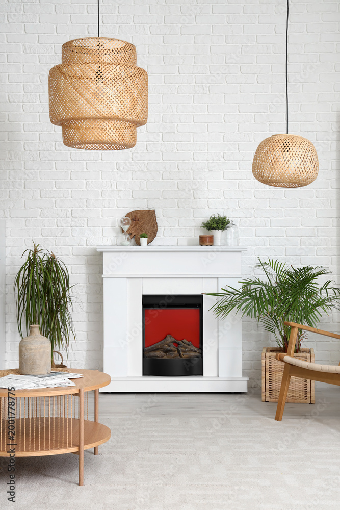 Fototapeta premium Interior of living room with modern fireplace, table and houseplants