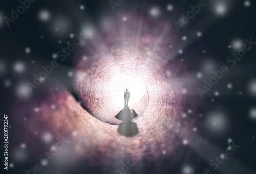 A man walks through a long tunnel toward a bright light. Topics: religion, God, soul, faith, light at the end of the tunnel, life after death, another world, freedom of choice, open mind, meditation.