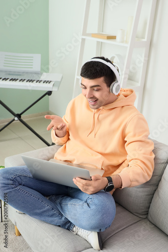 Young man in headphones wit...