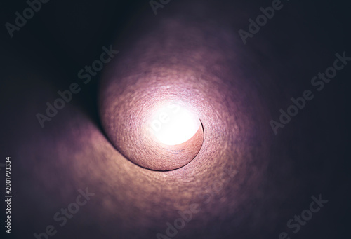 A bright light at the end of a long stone tunnel. Concepts of religion, God, soul, faith, light at the end of the tunnel, life after death, another world, freedom of choice, open mind, meditation.
