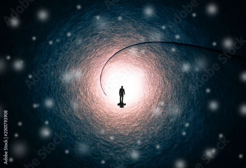 A man walks through a long tunnel toward a bright light. Topics: religion, God, soul, faith, light at the end of the tunnel, life after death, another world, freedom of choice, open mind, meditation.