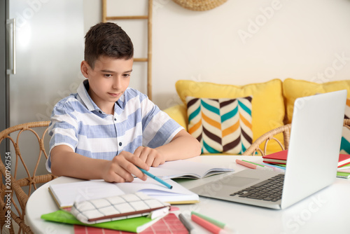 Little boy studying online ...