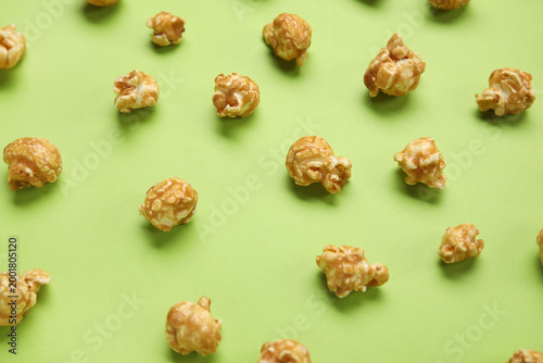 Tasty popcorn on green back...