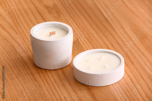 Holders with candles on woo...