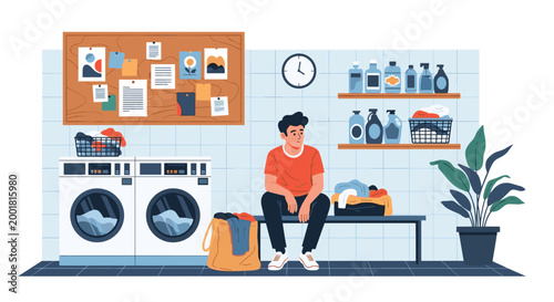 Young man waits patiently on a bench at a public laundromat while his clothes are being washed in front-loading machines near his laundry bag.