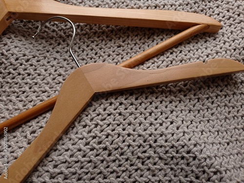 фотографія Close up of wooden clothes hangers of various sizes on a gray blanket