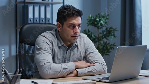 Serious Office Worker Facing Work Challenges and Work Stress With Frustration on the Laptop