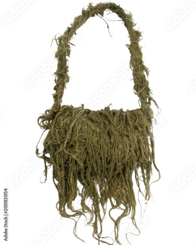 A handmade green woven bag hangs against a white background.
