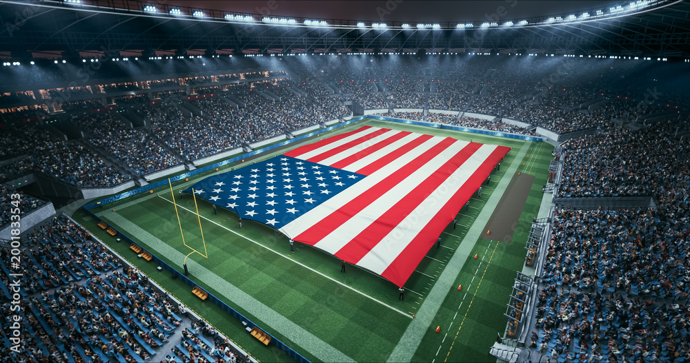 Naklejka premium Professional Stadium American Football Game Championship With Flag of United States Spread Across the Pitch Before Football Match Start. Cheering Crowds of Fans Surround the Field. Aerial Wide