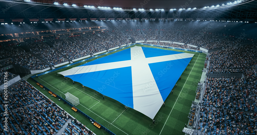 Fototapeta premium Professional Stadium Soccer Game Championship With Flag of Scotland Spread Across the Pitch Before Football Match Start. Cheering Crowds of Fans Surround the Field. Aerial Wide Shot
