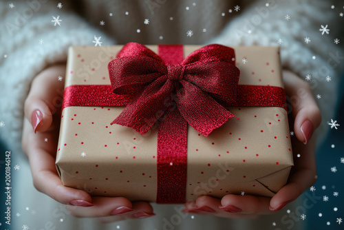 Holiday Banner Featuring Gift Box and Female Hands Against Blue Background