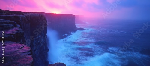 Dramatic cliff sunset over turbulent ocean