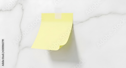 Yellow sticky note attached to a white textured surface copy space background