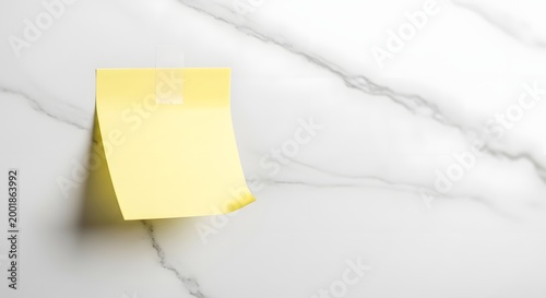 Yellow sticky note on a white marble surface for message and reminders