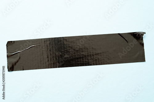 Folded adhesive tapes on a light blue background, minimal graphic texture with contrasts.