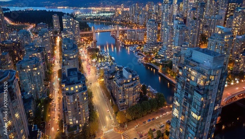 Aerial view of Vancouver city skyline at dusk with harbor.