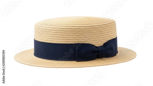 A classic straw boater hat with a flat crown, wide brim, and a dark navy blue grosgrain ribbon band with a side bow, isolated on black