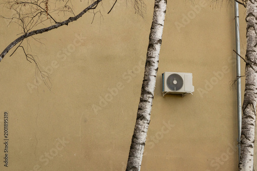 air conditioner, condenser unit, compressor on facade of building. unit of central AC conditioner of HVAC heating ventilation system. Indoor and office air cooling during seasonal temperature rise.