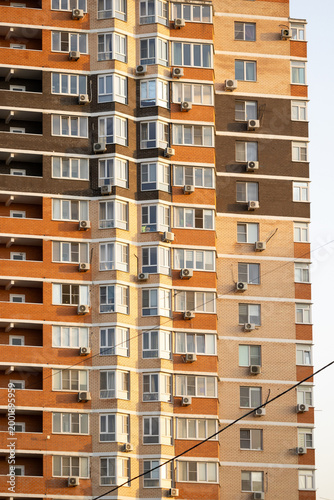 air conditioner, condenser unit, compressor on facade of building. unit of central AC conditioner of HVAC heating ventilation system. Indoor and office air cooling during seasonal temperature rise.