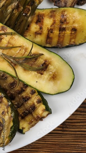 grilled vegetables in a white plate on a wooden background. Delicious healthy vegetarian snack. Healthly food