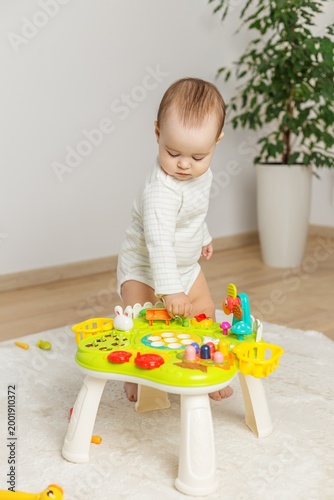 toddler baby playing with activity table at home learning and development