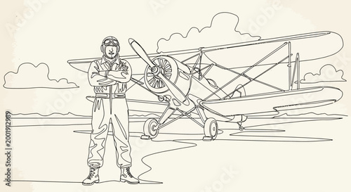 Vintage pilot standing by biplane aircraft.