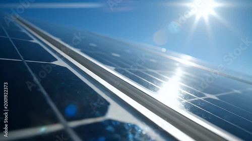 A close-up view showcases a solar panel glistening under bright sunlight, highlighting its intricate grid pattern and reflecting the sun's energy.
