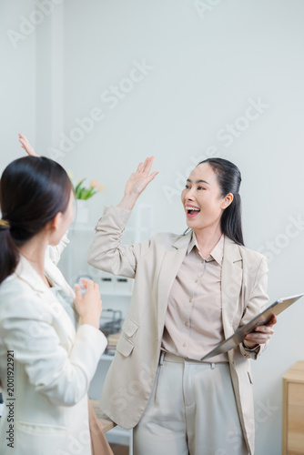 Asian woman succeeds at office