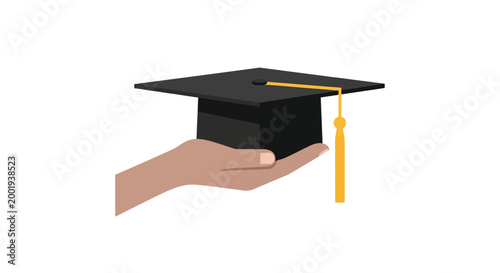 hand holding graduation cap with yellow tassel