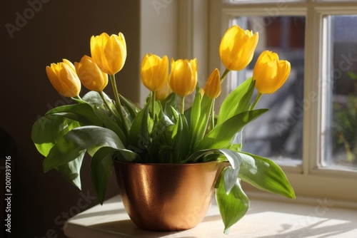 A cluster of yellow tulips in a copper pot on a windowsill
