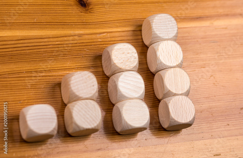 Wooden dice arranged in col...